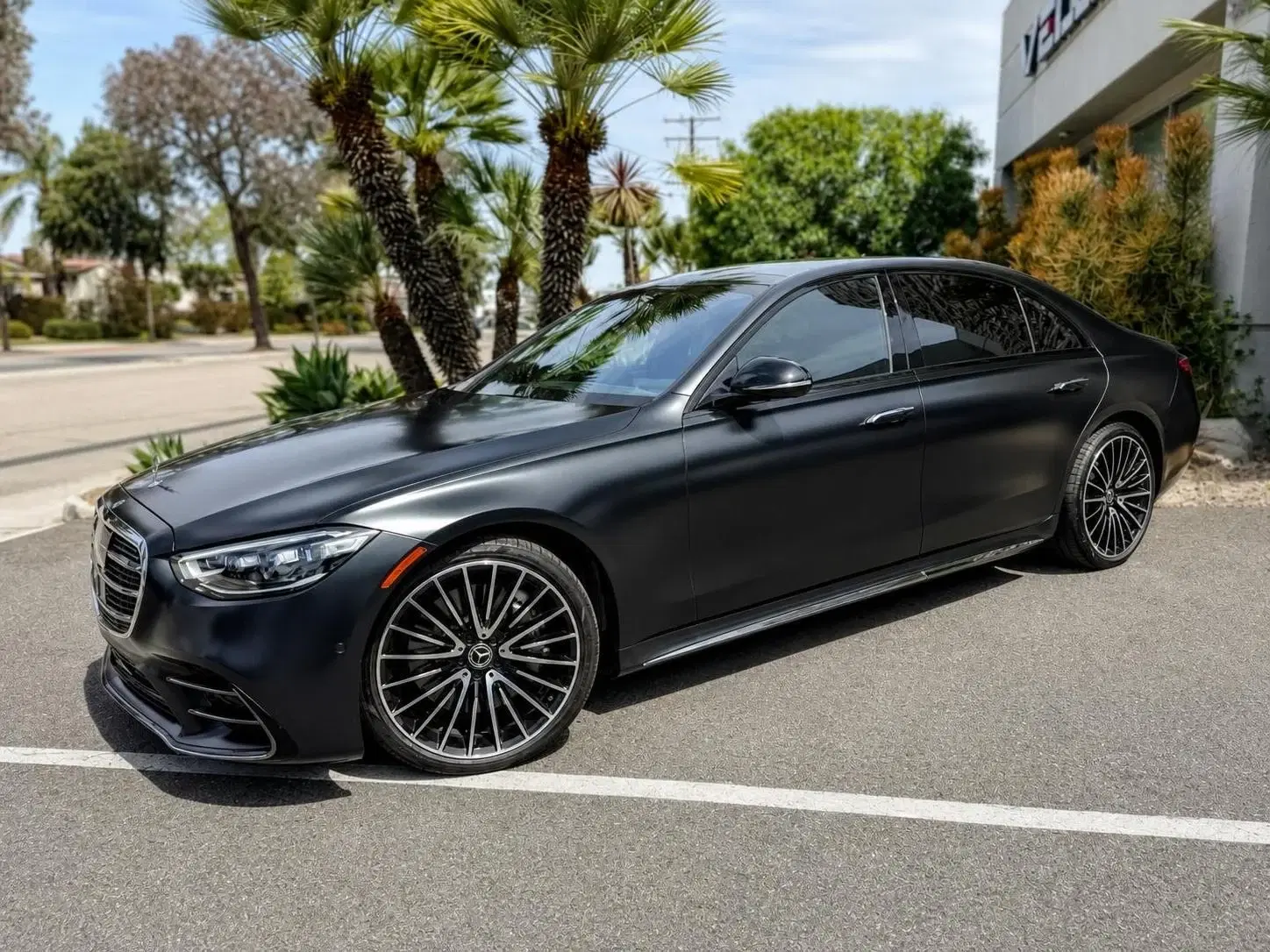 Dark sedan photographed from the front three-quarter angle